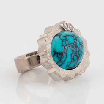 A Grima ring in 14K white gold set with a turquoise and round brilliant-cut diamonds.