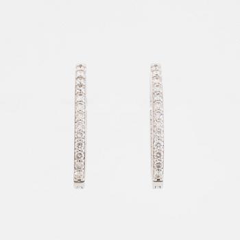 Brilliant-cut diamond hoop earrings.