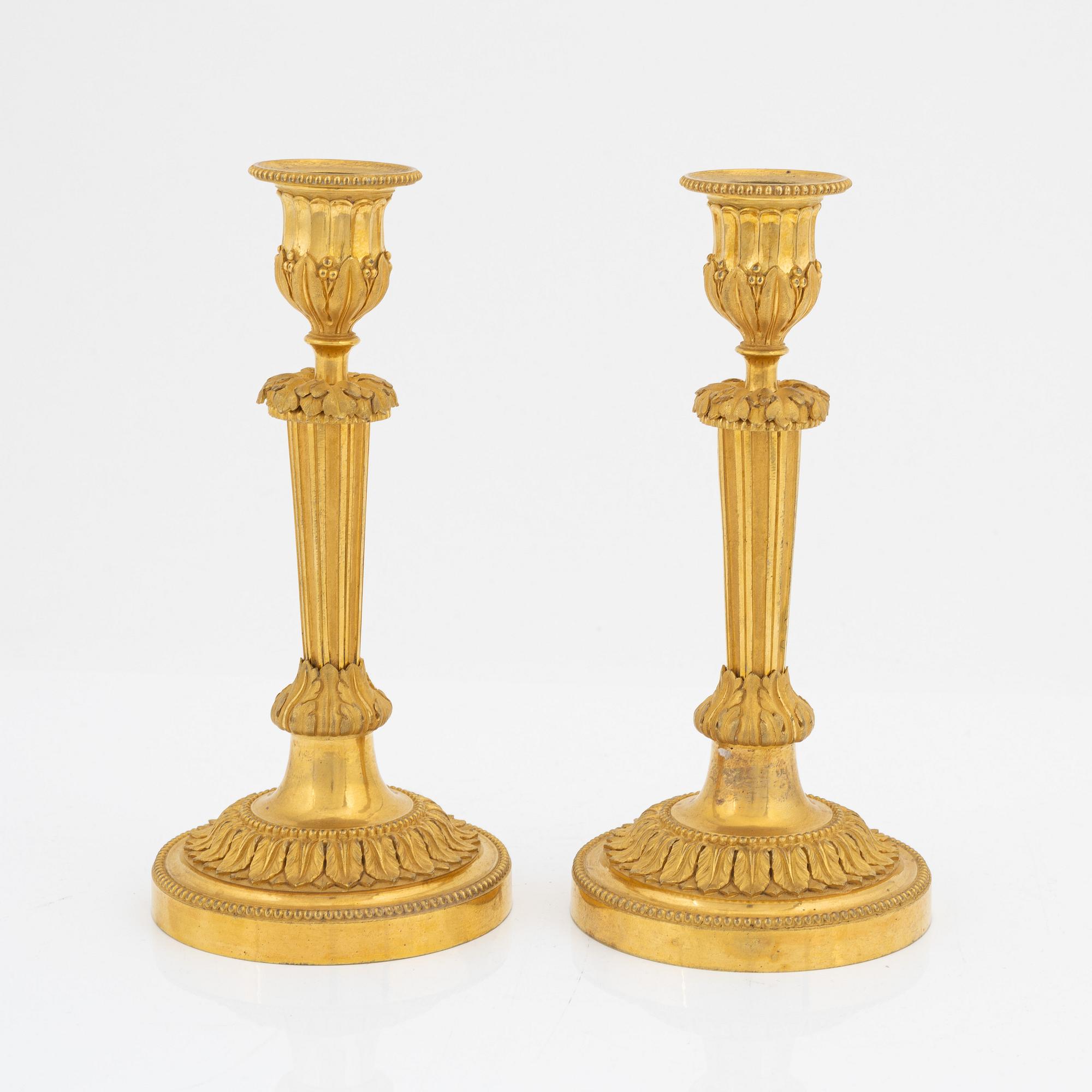 A pair of gilded bronze candelsticks, 19th Century.