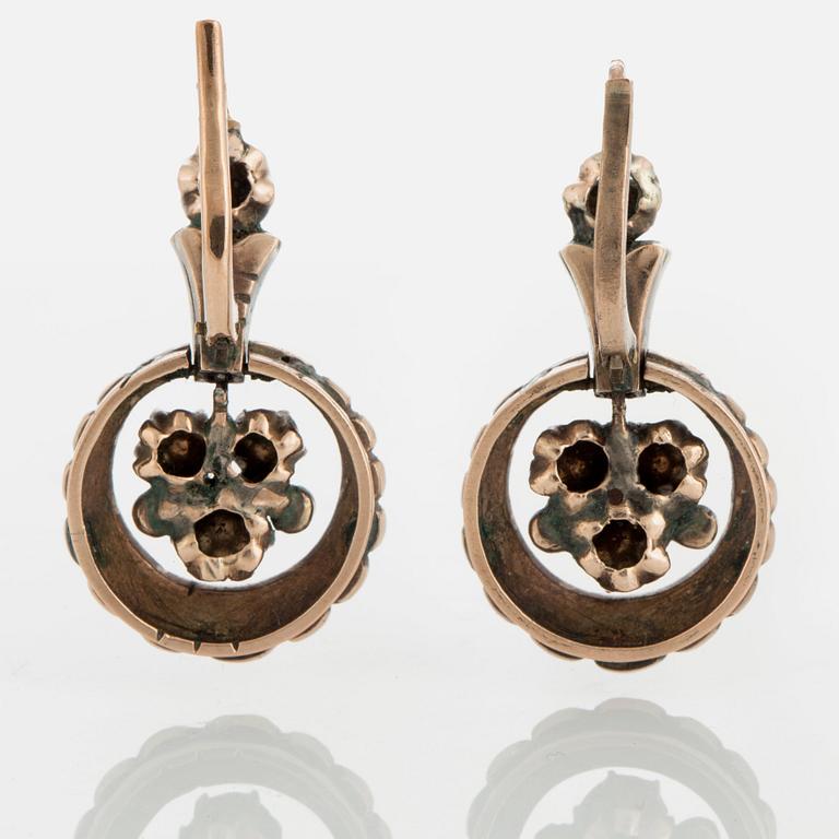 A pair of earrings set with rose-cut diamonds.