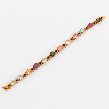 A WA Bolin bracelet in 18K gold set with coloured gemstones.