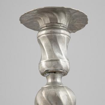 A pair of rococo style pewter candlesticks, 19th Century.