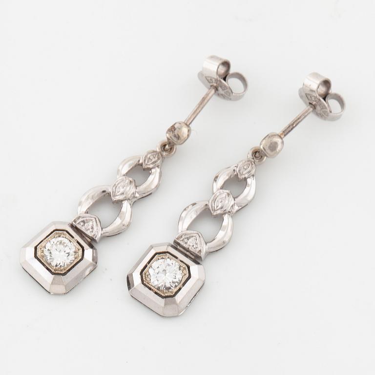 A pair of brilliant cut diamod earrings.