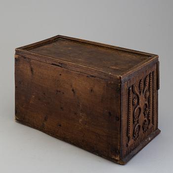 A 19th century wooden box with drawers.