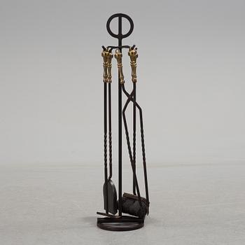 A set of 5 iron and brass fire utensils with stand, 20th Century.