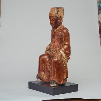 A seated, gilded and lacquered wooden scultpure of a mandarin official, Qing dynasty, 19th Century.