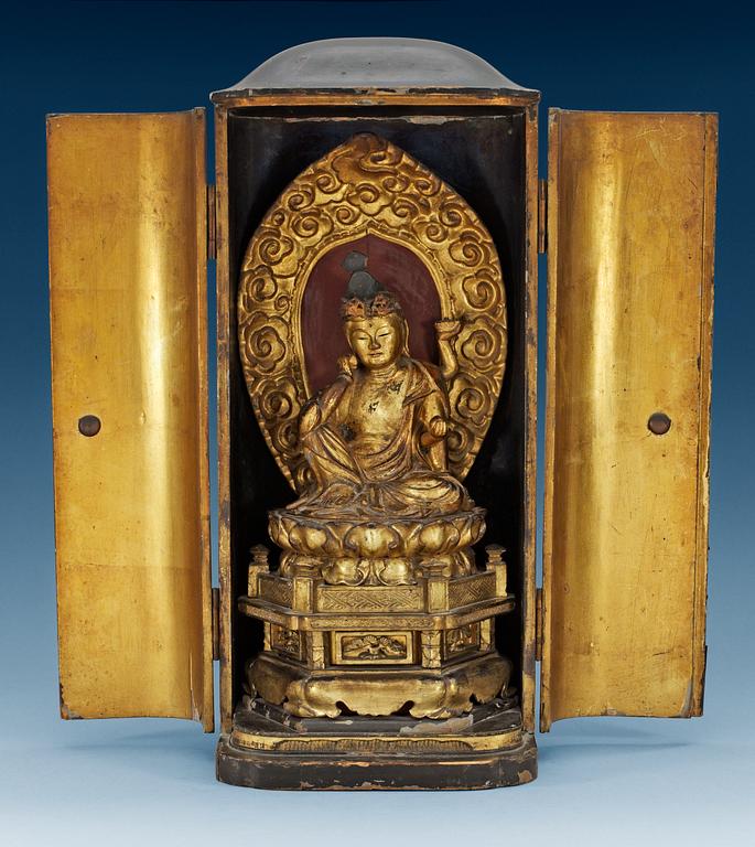 A Japanese gilt lacquer figure of seated Buddha in a wooden shrine, 19th Century.