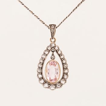 An 18K gold and silver necklace set with an oval faceted morganite and rose-cut diamonds.