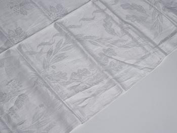 A tea table cloth, linen damask, "Lilla blomsterkorgen", ca 143,5 x 144 cm.