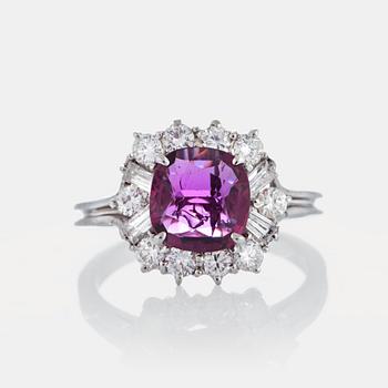 1075. A ring set with a ruby ca 1.85 cts and round-brilliant and trapez-cut diamonds.