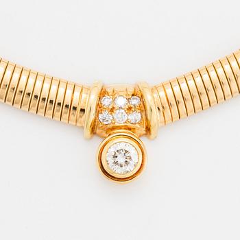 An 18K gold necklace set with a round brilliant-cut diamond.