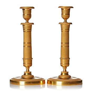 130. A pair of French gilded Empire candlesticks.