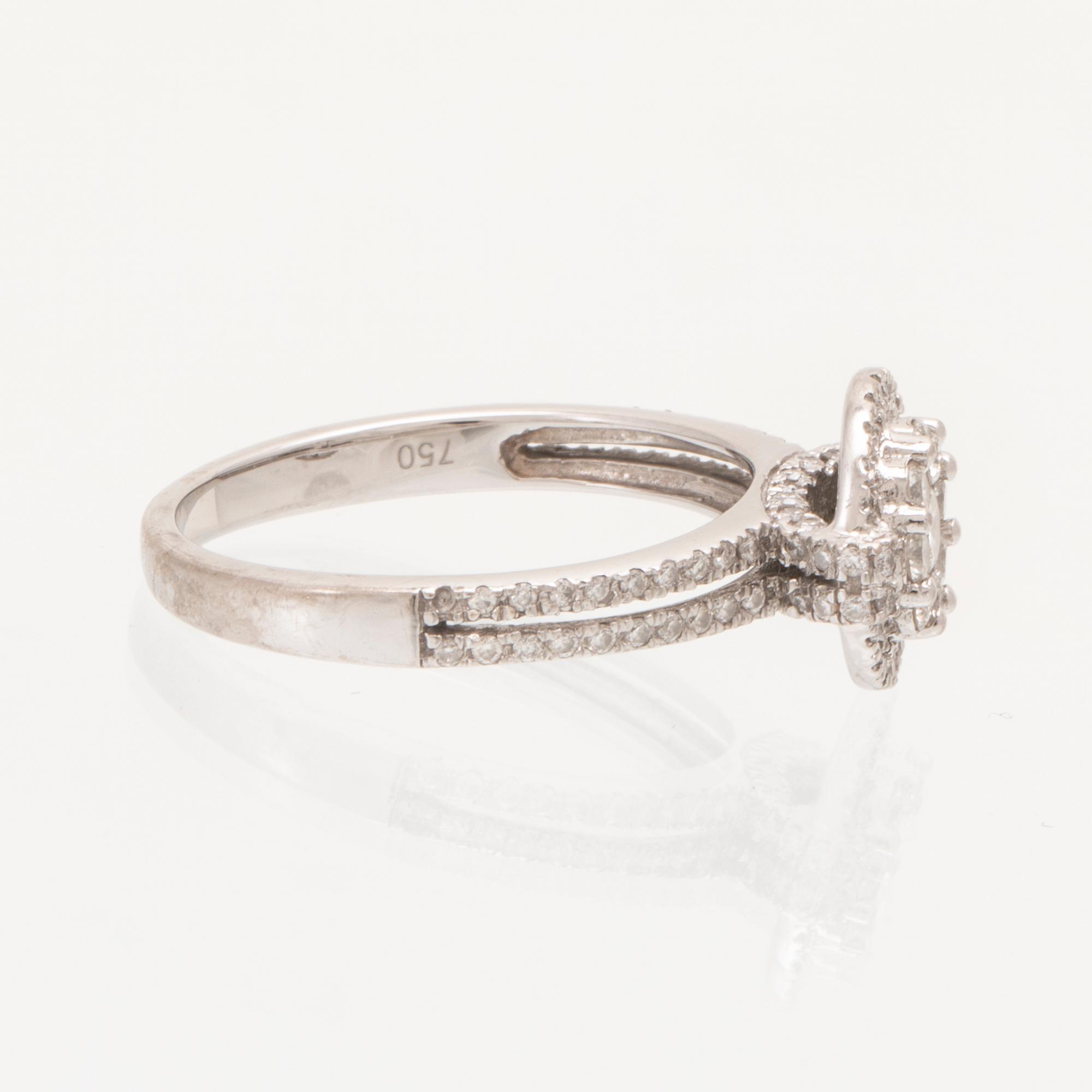 An 18K white gold ring set with round brilliant-cut diamonds.