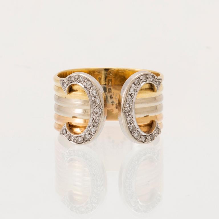 A Cartier "Double C" ring 18K tricolor gold set with round single-cut diamonds.