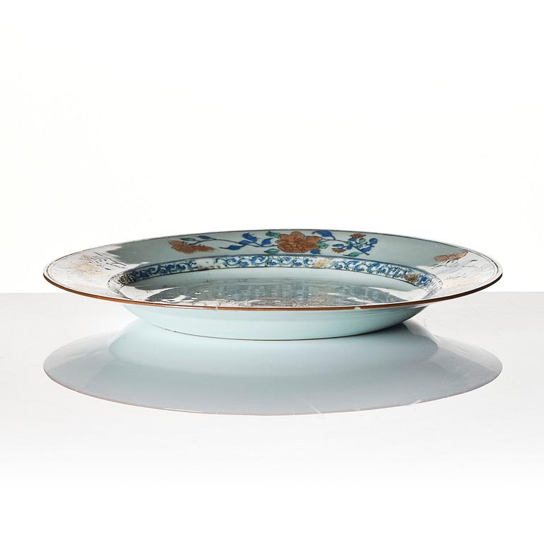 A Chinese Export armorial dish and seven plates, Qing dynasty, 18th Century.