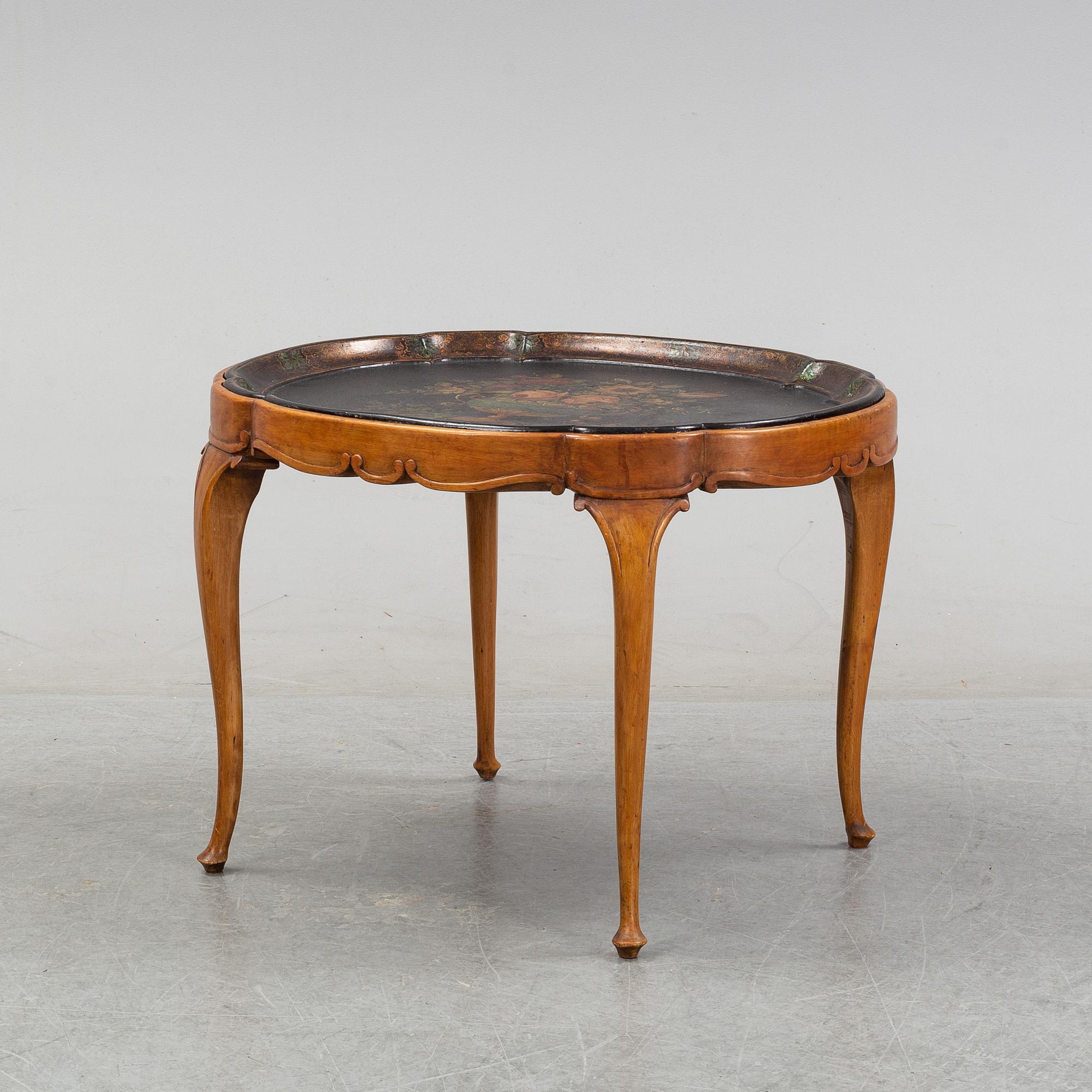 A rococo style side table with a loose tray.