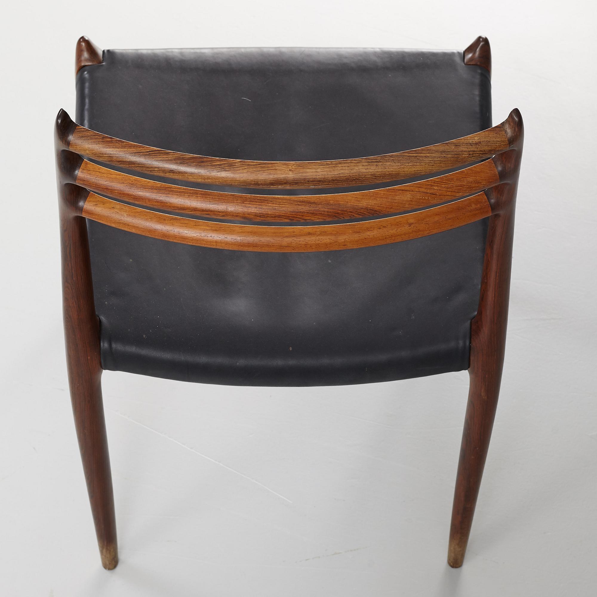 Niles Otto Møller, a rosewood veneered table with four chairs, JL Møller, Denmark, 1950's/60's.