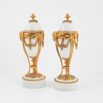 A pair of French Louis XVI-style ormolu and marble cassolettes, later part of the 19th century.
