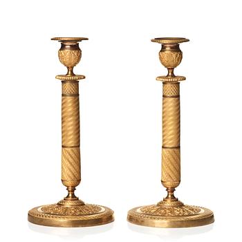 123. A pair of Empire candlesticks.