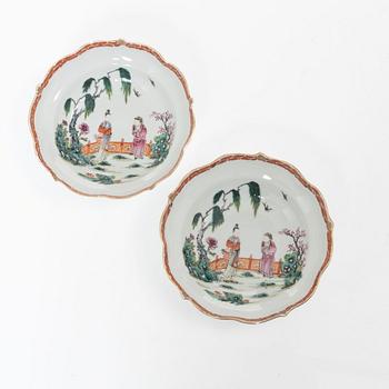 A pair of Chinese famille rose teacups with saucers and a pair of plates and two dishes, Qing dynasty, 18th century.