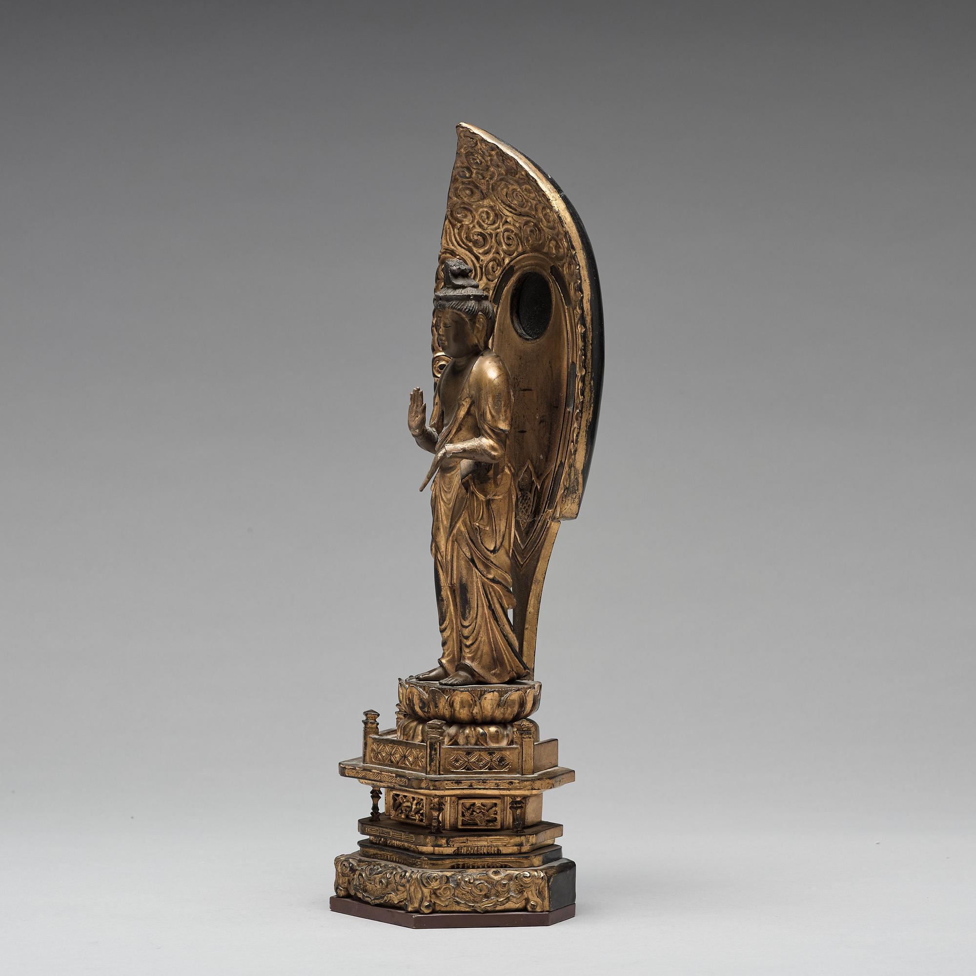 A Japanese gilt and lacquered wooden figure of Buddha and a travel shrine, Edo Period, 19th century.