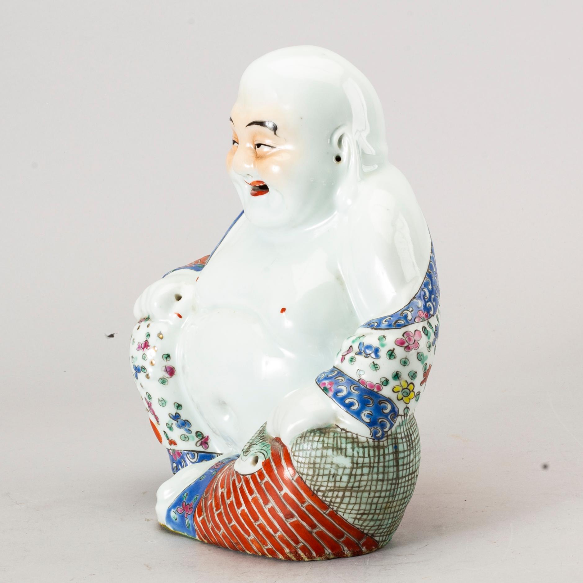 A Chinese porcelain buddha, 20th century.