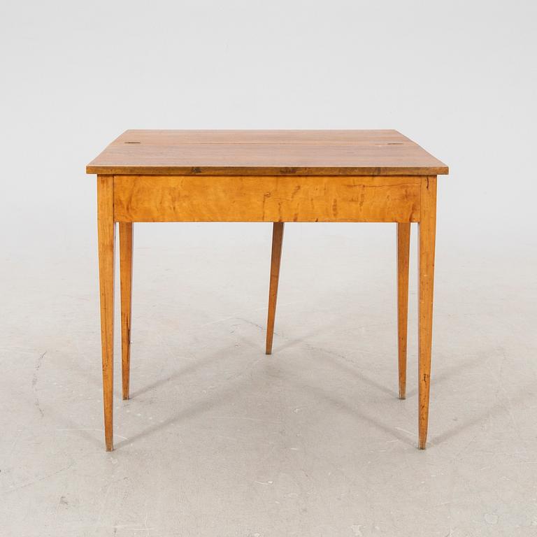 An earluy 1900s birch game table.