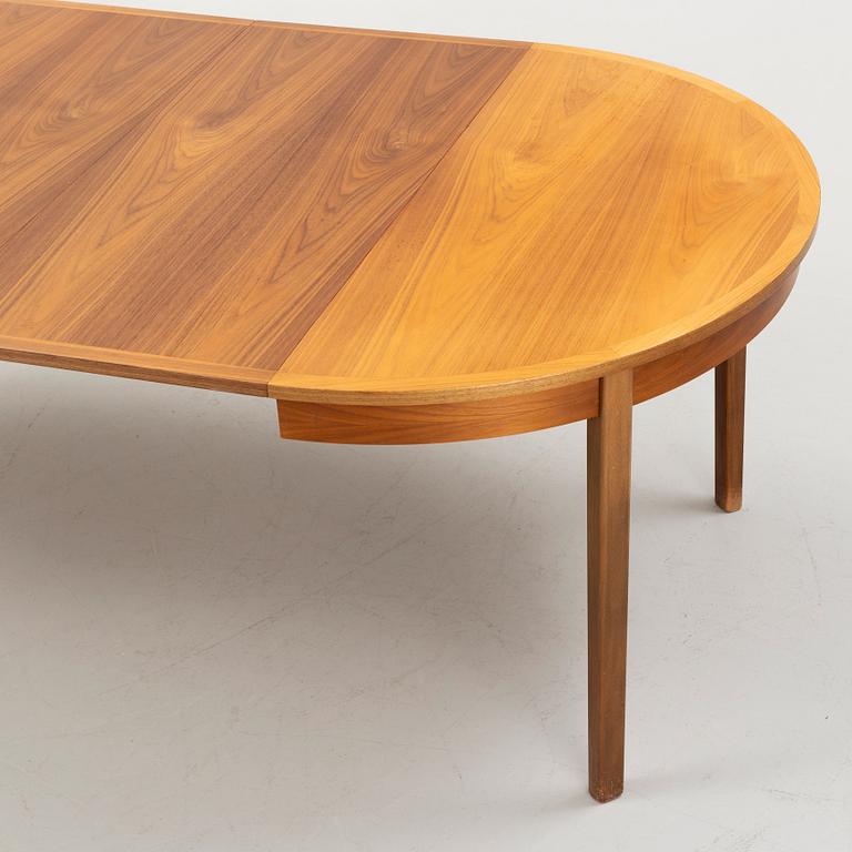 A walnut-veneered dining table, 1960's/70's.