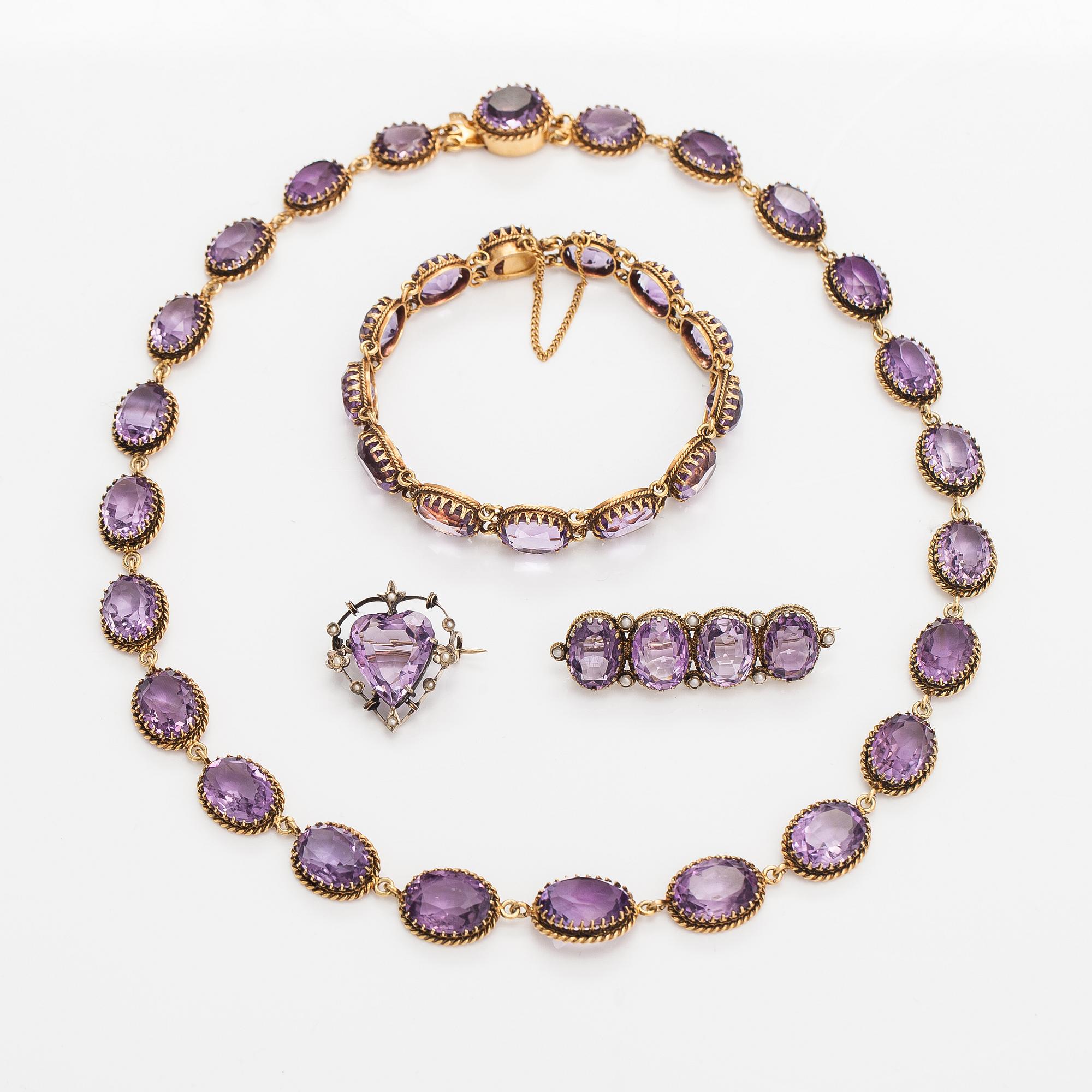 A necklace, bracelet and two brooches in gilded silver and with amethysts and pearls.