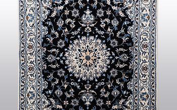 A rug, Nain, part silk, ca 242 x 167 cm.
