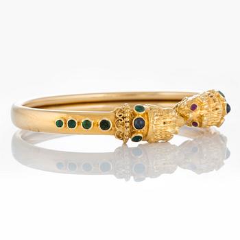 An Ilias Lalaounis bracelet in 18K gold set with emeralds, sapphires and rubies.