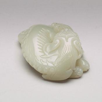 A Chinese nephrite figure of a reclining buddhist lion and its cub, presumably circa 1900.