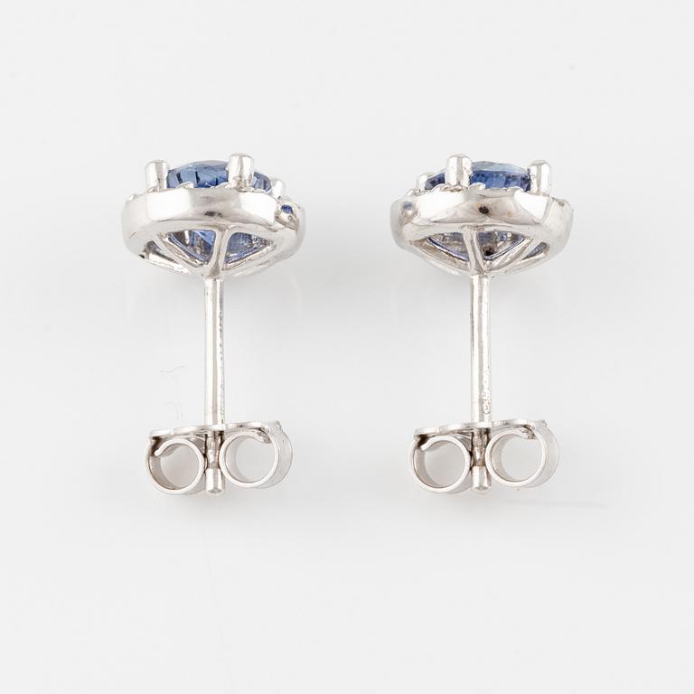 A pair of 18K gold earrings with faceted sapphires and round brilliant-cut diamonds.
