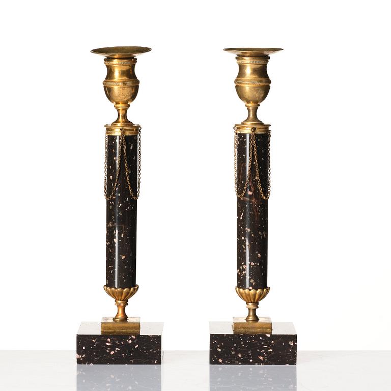 A pair of late Gustavian porphyry and gilt brass candlesticks, circa 1800.
