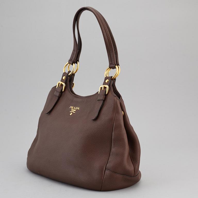 PRADA, a brown leather bag.