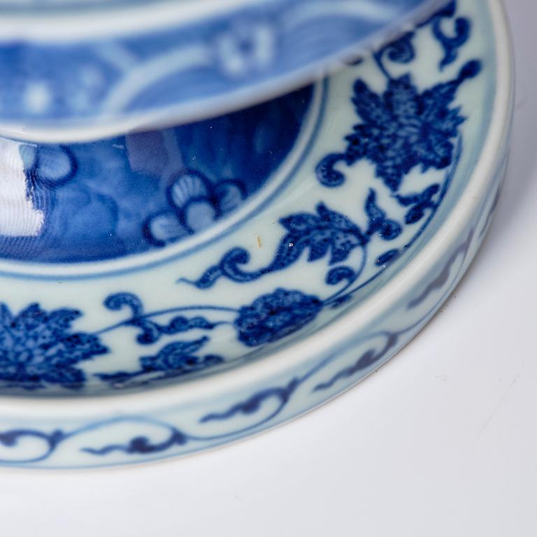 A pair of blue and white pricket candle sticks, with a poem, Qing dynasty with a Qianlong mark and of the period.