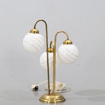 A brass and metall table lamp from the second half of the 20th century.