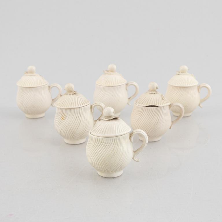 A set of six soft-paste porcelain custard cups with covers, 18th century.