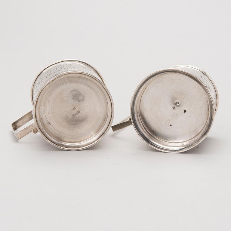 Two tea glass holders in silver, one with mark of Ivan Saltykov, Moscow 1889, the other one marked Moscow 1908-1917.