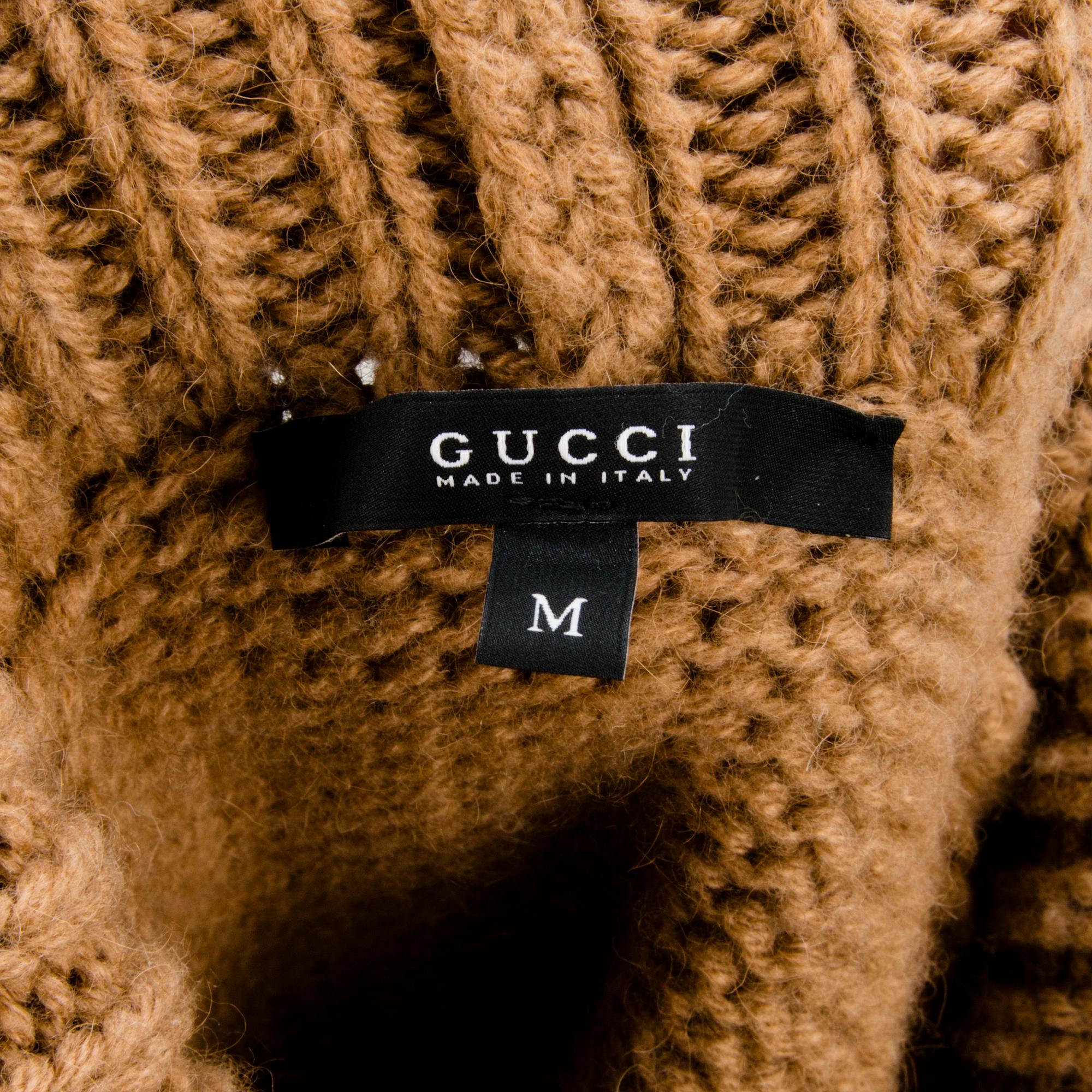 GUCCI, CAMEL HAIR PONCHO AND A HAT.