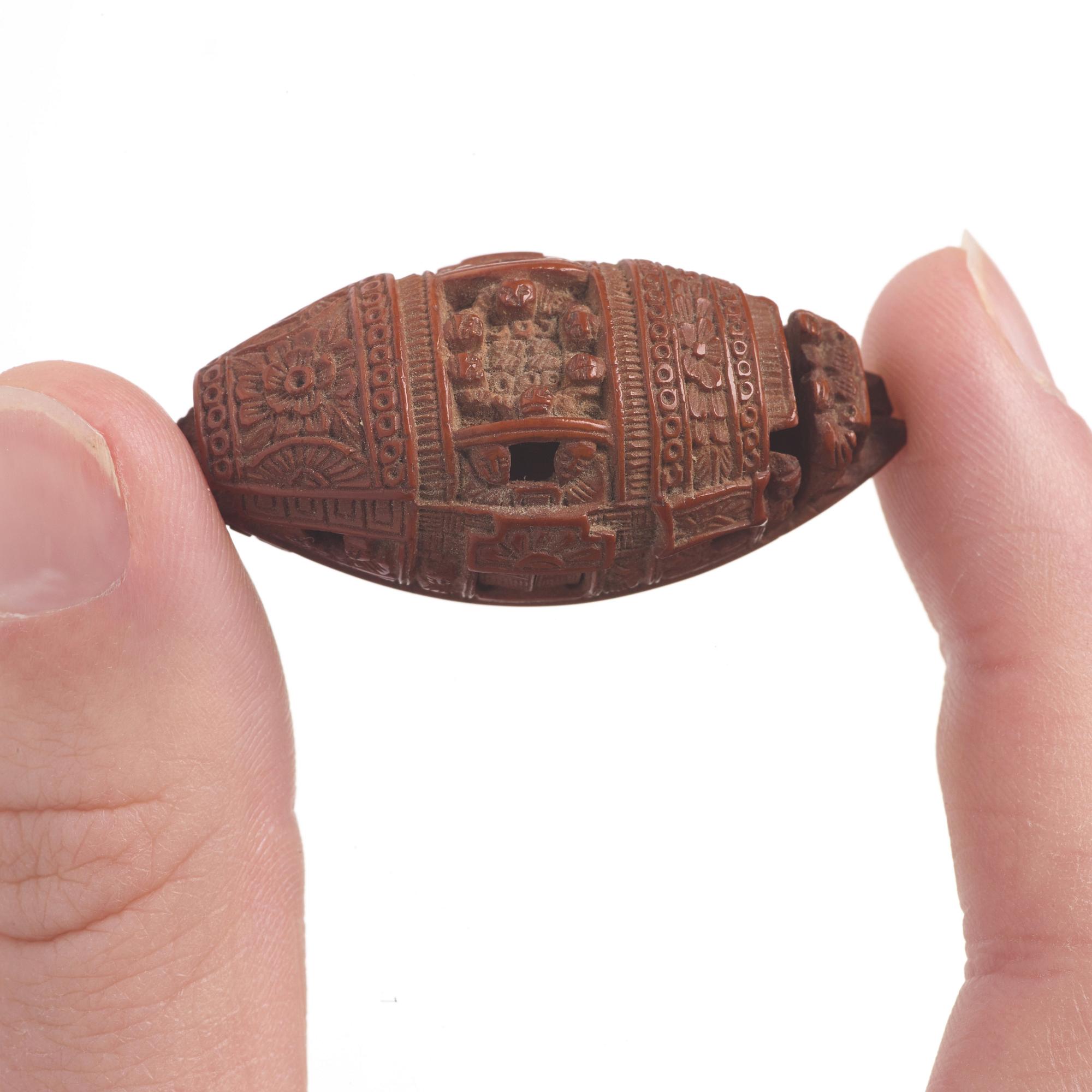 A Chinese nut boat sculpture, with poem.