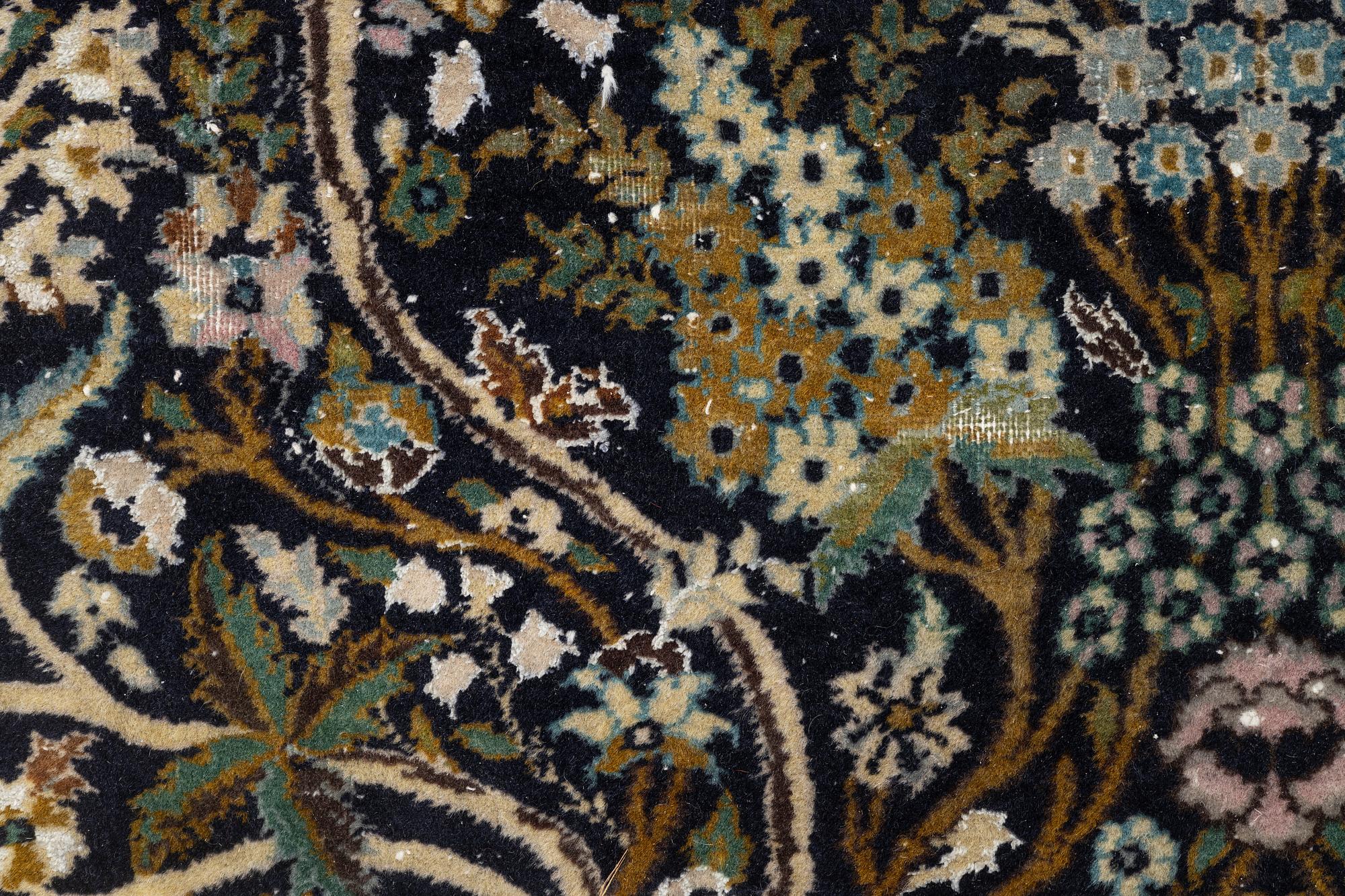 A figural Quum carpet, c. 179 x 125 cm.