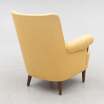 Carl Malmsten, a 'Hemmakväll' armchair and a 'Farmor' ottoman.