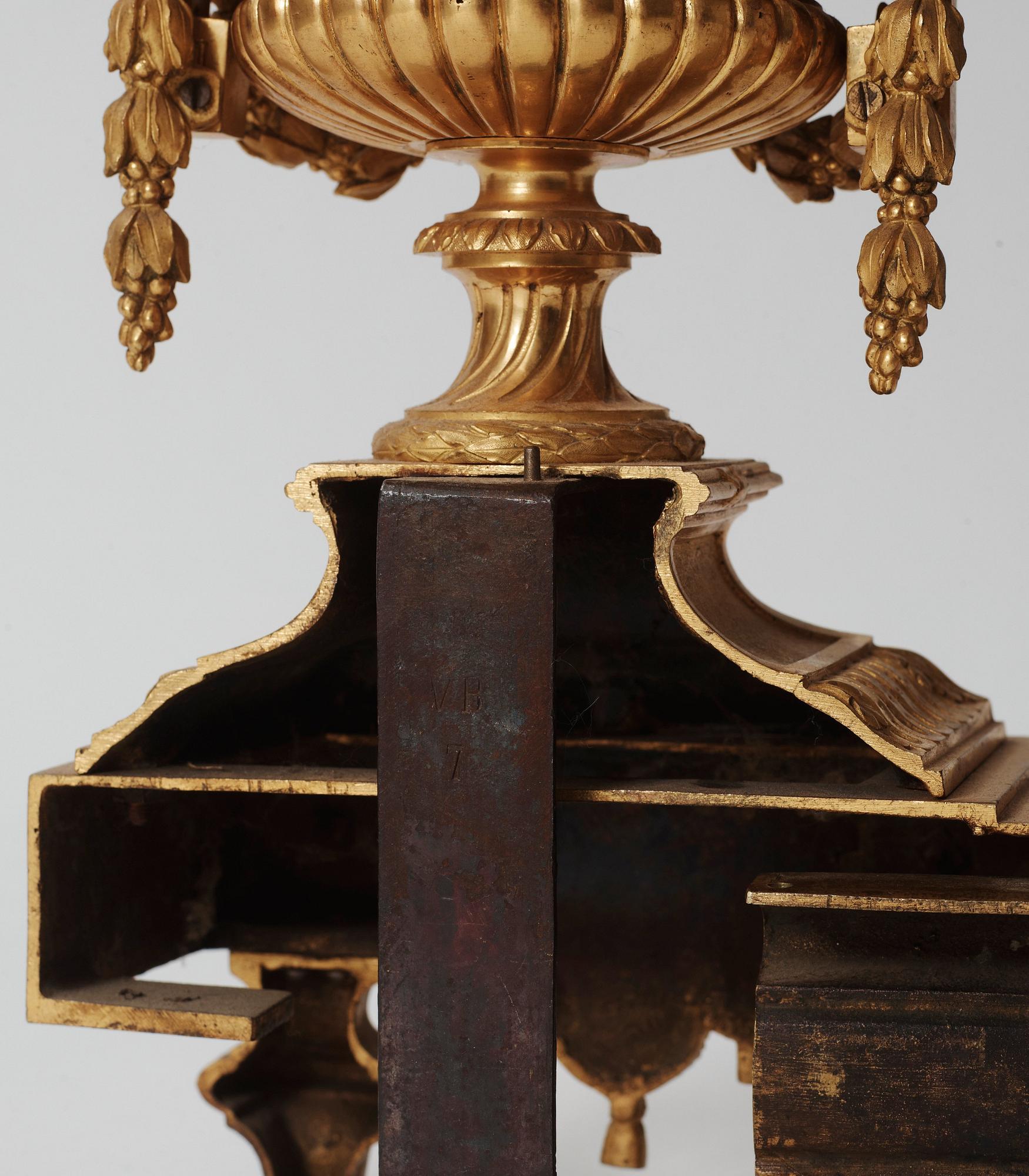 A pair of French Louis XVI-style 19th century gilt bronze fire dogs.