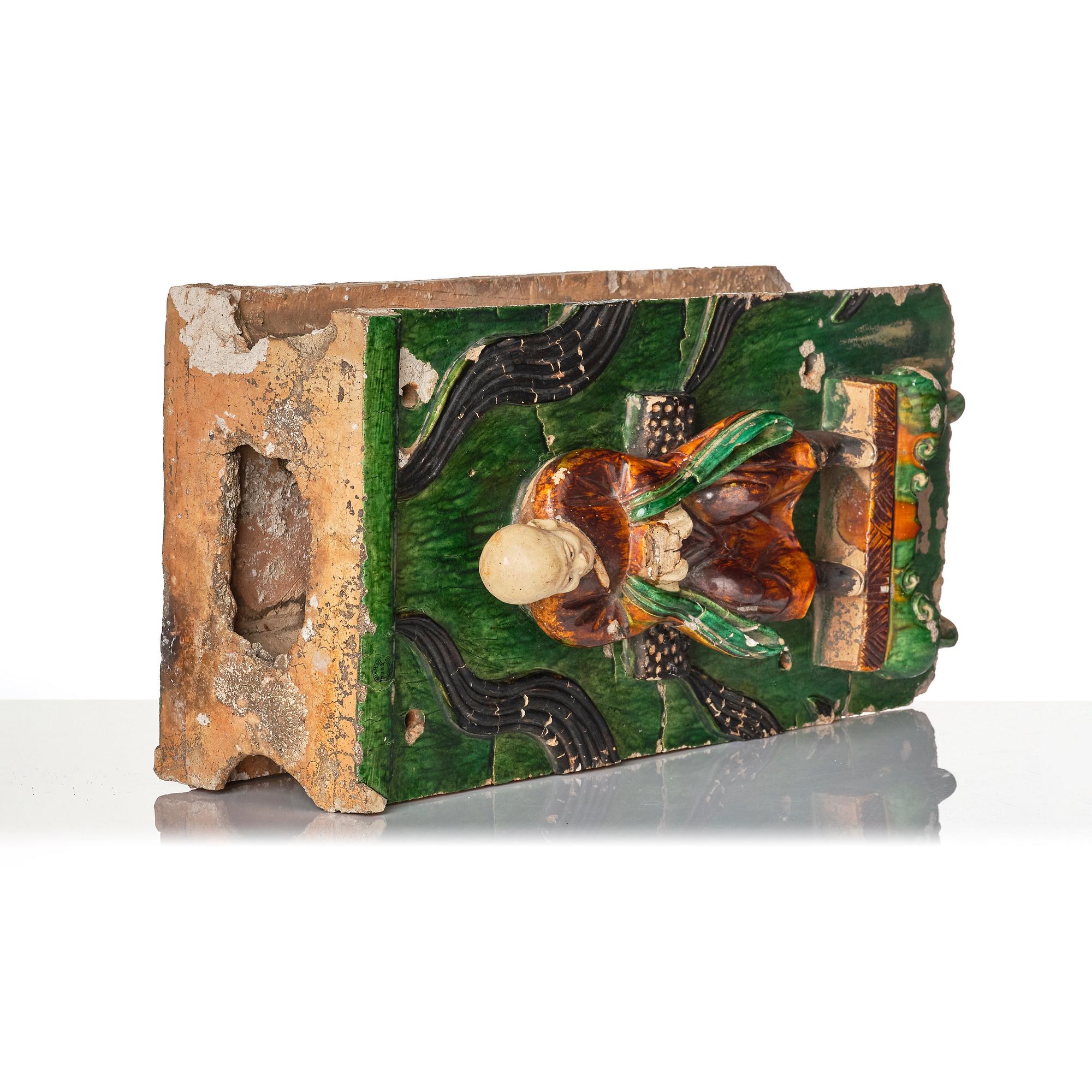 A green and yellow glazed architectural element with a Lohan, Ming dynasty (1368-1644), dated 1536.