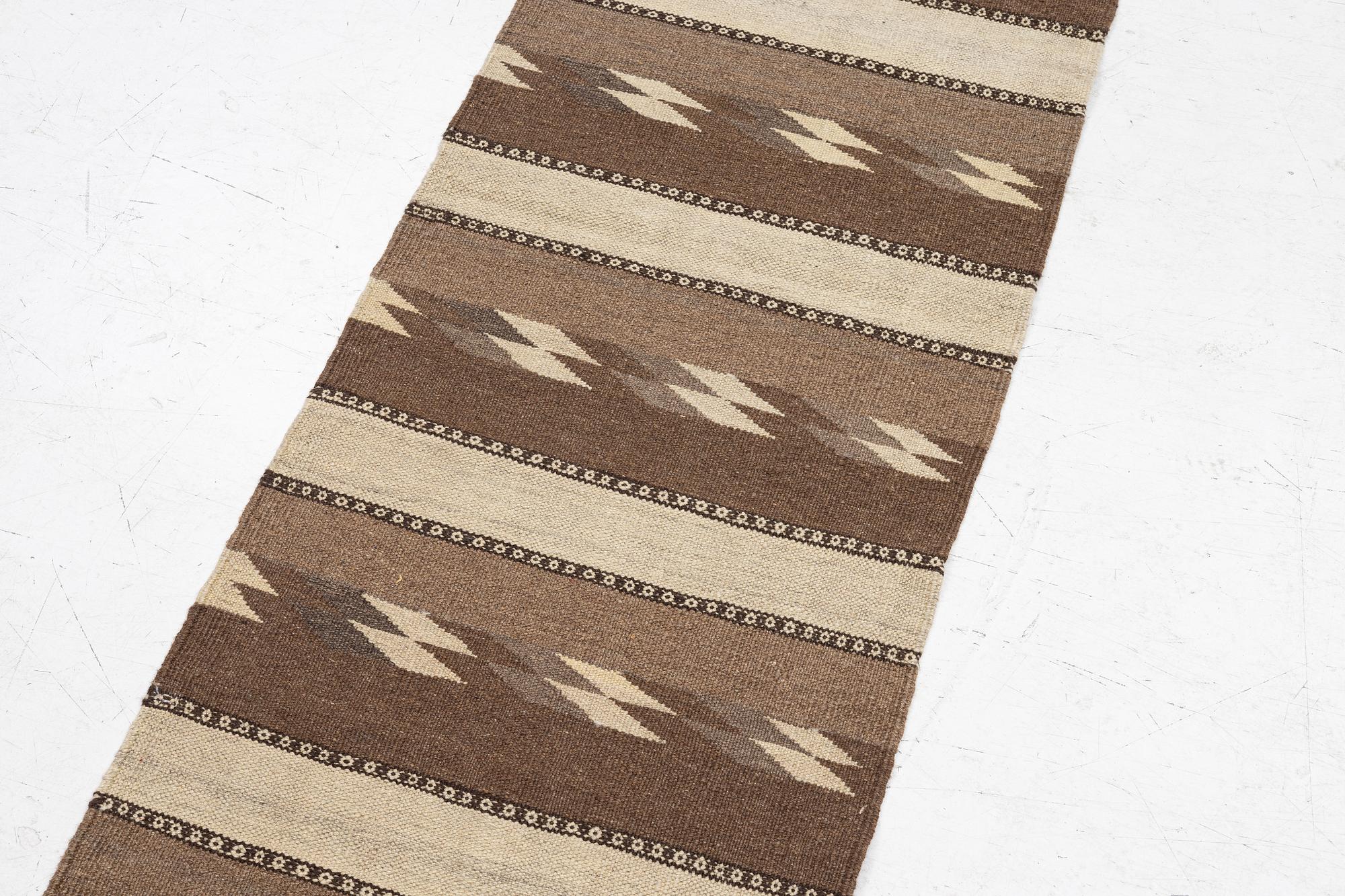 A Persian kilim runner, c. 248 x 62 cm.