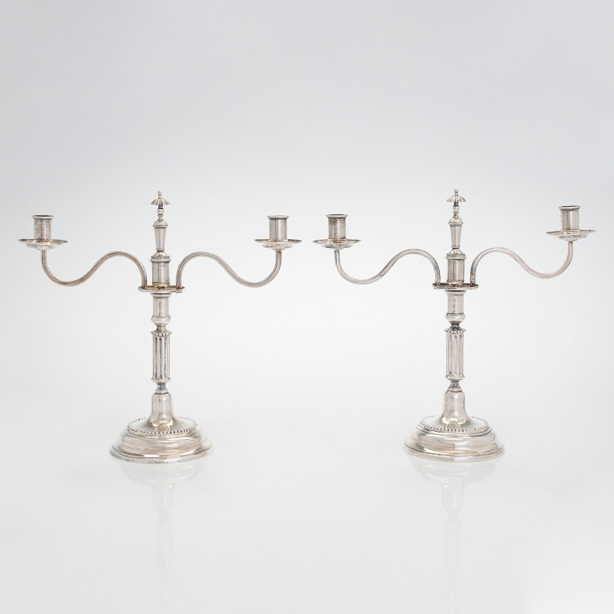 A pair of silver candelabra by Ferdinand Christian Krebs, Breslau, 1776-1792, with snuffers from Reval. Neo-classicism.