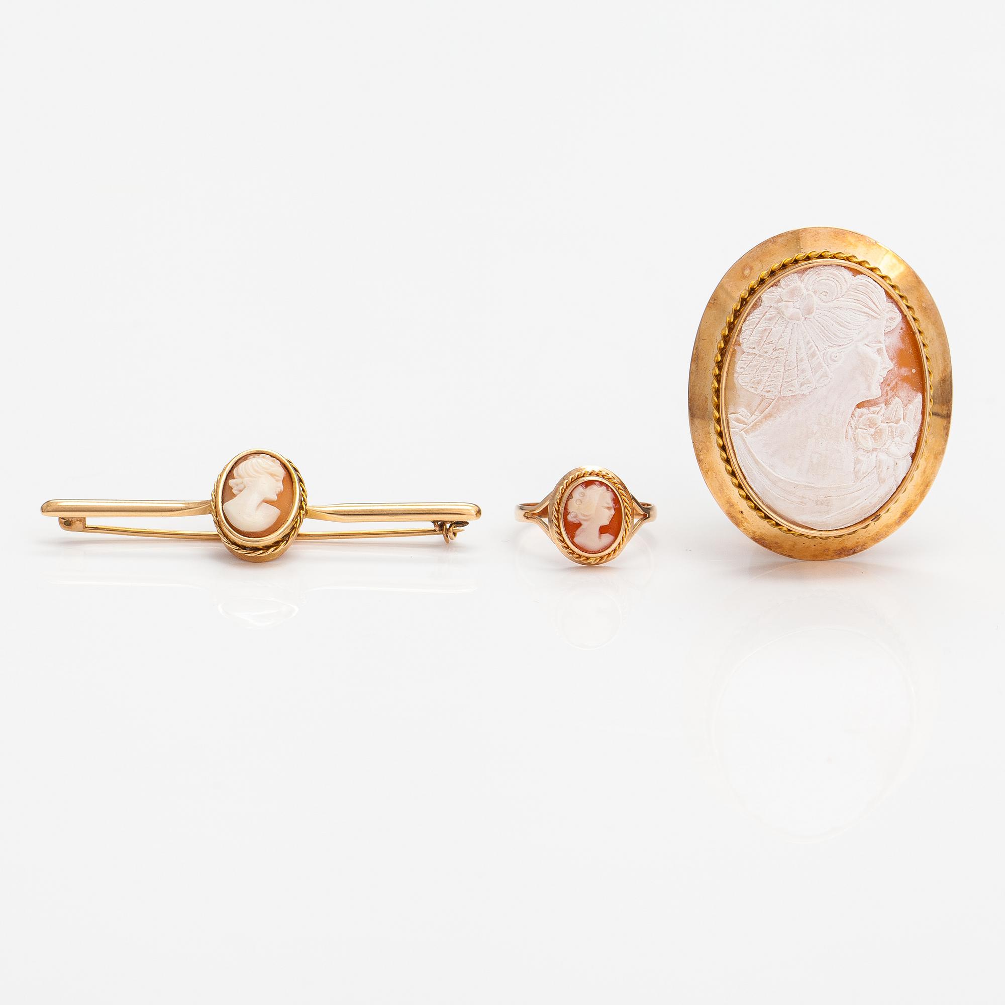 Two brooches and a ring, 14K and 18K gold and sea shell cameos.