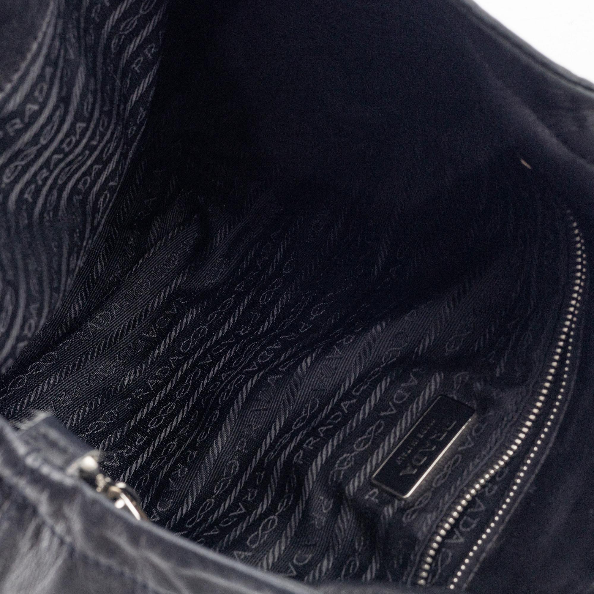 Prada, A black leather bag.