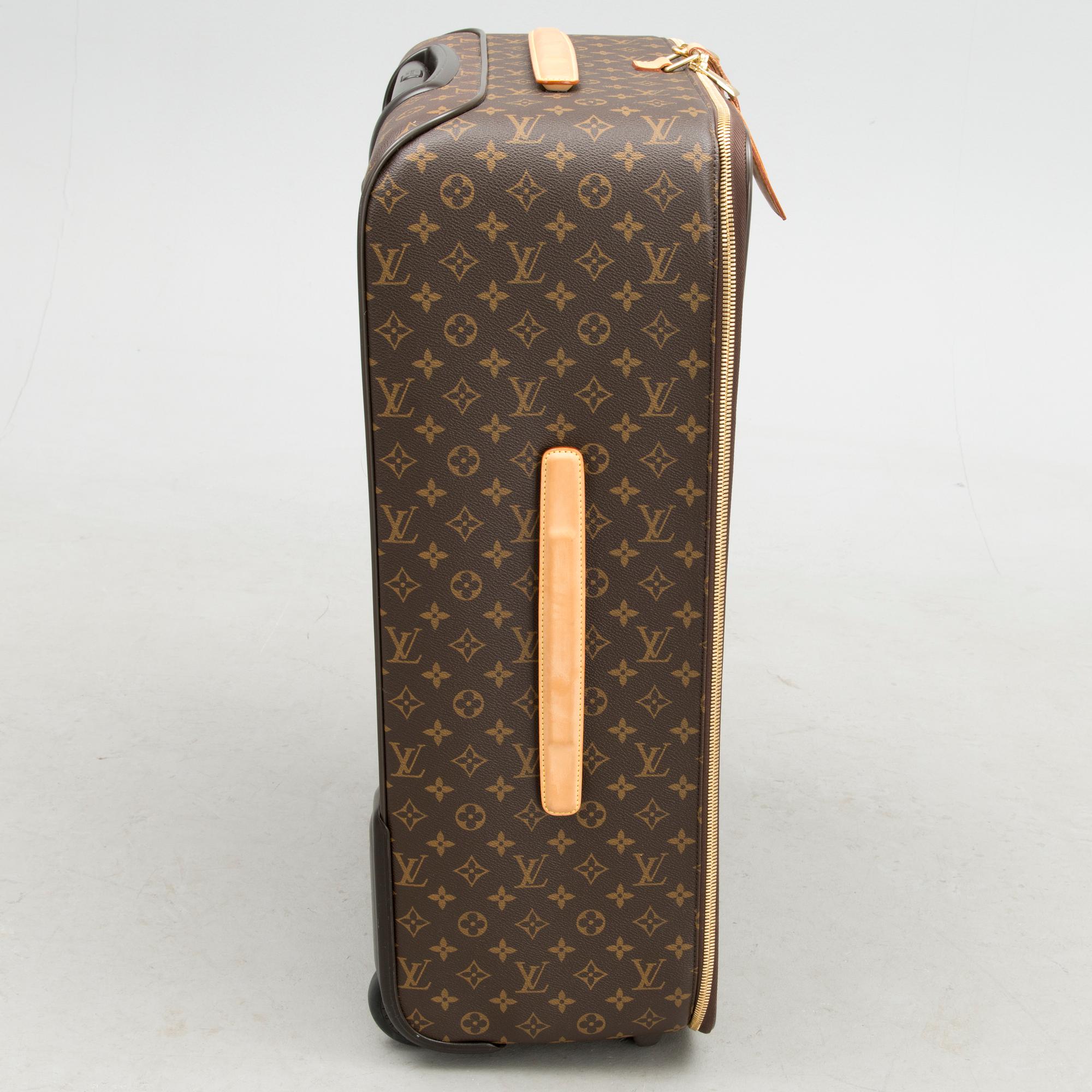 A Monogram Canvas Pégase 65 Suitcase with a Protective Cover.